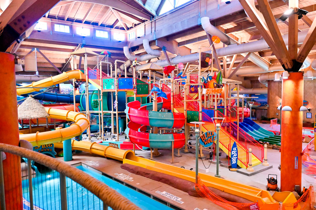 A large indoor water park with lots of slides.