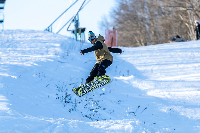 A person riding a snowboard in the snow.